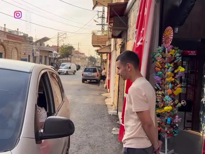 A staff member at the door taking an order from a driver